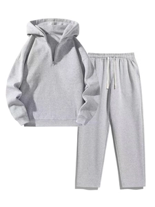 Detail of the soft cotton fabric texture on the grey sweatshirt and drawstring pants