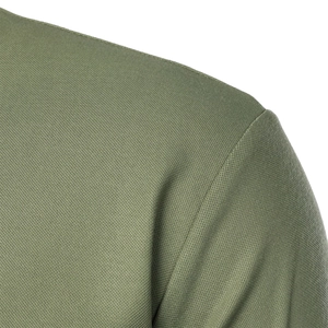 Close-up of olive green polo shirt fabric showing breathable mesh texture and shoulder stitching