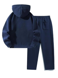 Detail of navy blue tracksuit showing elastic waistband and back pocket of wide leg pants