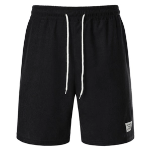 Close-up of black corduroy shorts featuring elastic waistband, white drawstrings and logo
