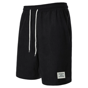 Detailed close-up of men's black corduroy shorts showing white drawstring and sports patch