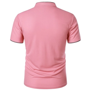 Detail view of pink polo shirt back showing pique cotton texture and black trim edges