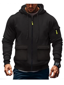 Detail of black zip-up hoodie with neon green drawstrings and tactical cargo pockets