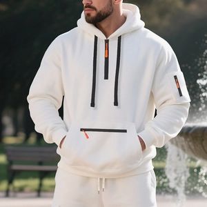 Detail of white fleece hoodie featuring a half-zip neckline and orange zipper accents