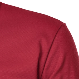 Close-up of red polo shirt showing breathable mesh texture and shoulder seam detail