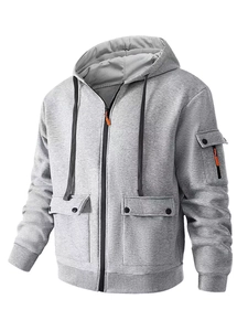 Detail view of light grey hoodie with large button pockets and orange zipper on sleeve