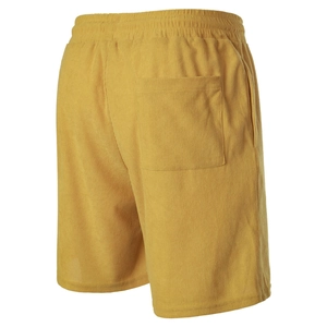 Detailed view of yellow corduroy shorts featuring elastic waistband and back pocket texture
