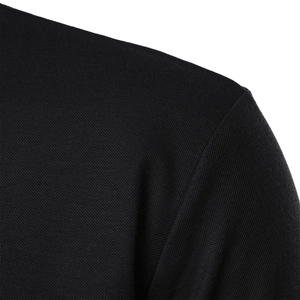 Close-up macro of black pique knit fabric texture and seam detail on a slim polo shirt