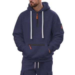 Detail of navy blue hoodie featuring functional orange zipper pulls and sleeve pockets