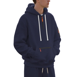 Detail of navy blue hoodie with half-zip collar, white drawstring and orange zipper accents