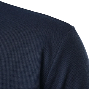 Close-up of navy blue polo shirt shoulder seams with breathable micro-mesh fabric texture