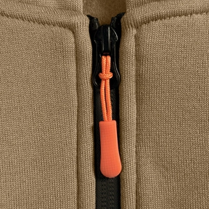 Dettaglio della giacca con cappuccio kaki con cerniera nera e cordino decorativo arancione