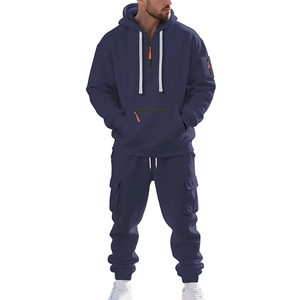 Détail du sweat à capuche bleu marine avec zips orange et poche tactique sur la manche