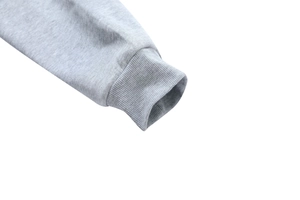 Detail view of high-elasticity ribbed cuffs on a grey cotton blend hoodie for men