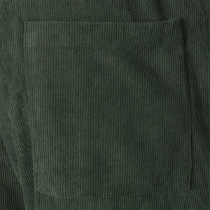 Detailed macro view of forest green corduroy fabric and square pocket stitching on shorts