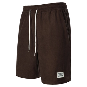 Detail of dark brown corduroy shorts featuring elastic waistband and white drawstrings