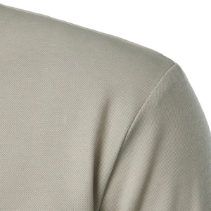 Close-up of shoulder stitching on light khaki polo shirt with textured fabric grain