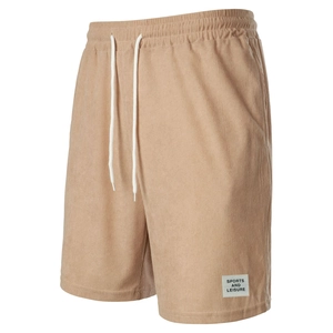Detail of khaki corduroy shorts featuring elastic waistband and sports leisure label