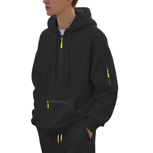 Detail of heavyweight black hoodie featuring neon yellow zipper and side arm pocket