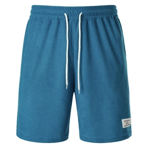 Detail of navy corduroy shorts showing textured fabric and white drawstring waist