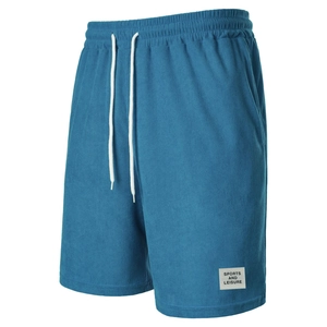Detailed texture of blue corduroy shorts with elastic waist and white drawstring