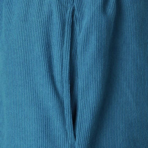 Detailed macro view of the corduroy fabric texture and side pocket on blue sports shorts