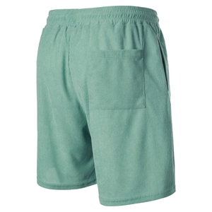 Detail view of mint green corduroy shorts showing elastic waistband and square back pocket