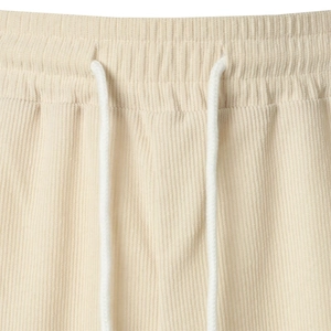 Detail of corduroy shorts waistband featuring elastic band and white woven drawstrings