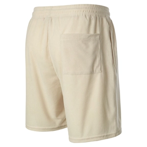 Detail view of corduroy shorts showing textured fabric and elastic waistband with back pocket