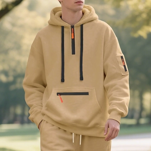 Detail of khaki men's heavy hoodie with black half-zip and bright orange puller