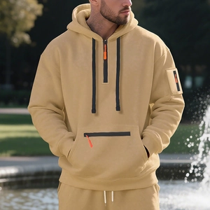 Detail of khaki men hoodie with half-zip orange puller and drawstring on park background