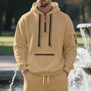 Detail of men's khaki fleece hoodie featuring half-zip collar and orange zipper pull accent