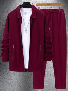 Detail of burgundy waffle knit jacket and drawstring trousers on a hanger setup