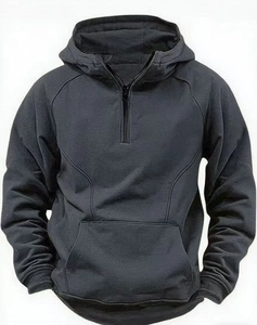 Detail view of charcoal grey half-zip hoodie featuring kangaroo pocket and ribbed cuffs