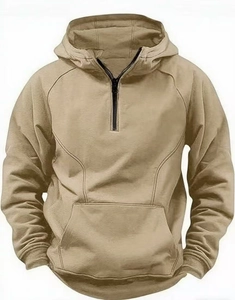 Detail view of khaki half-zip hoodie featuring raglan sleeves and a spacious kangaroo pocket