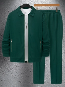 Detail of dark green waffle knit texture on men's zip jacket with zippered pockets
