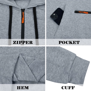 Detail view of grey hoodie showing zipper with orange puller, pockets and ribbed cuffs
