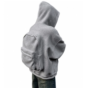 Detail of the gray hoodie featuring a unique integrated large capacity backpack zipper pocket