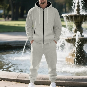 Detail of light grey fleece-lined tracksuit with black zipper and elastic ribbed cuffs