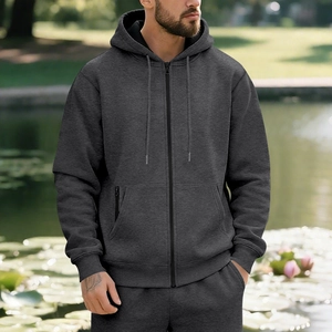 Detail of dark grey zip-up hoodie and joggers set with ribbed cuffs and kangaroo pockets