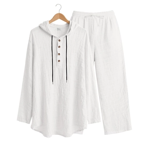 Close-up of white linen texture with wooden buttons and drawstring on men's casual set