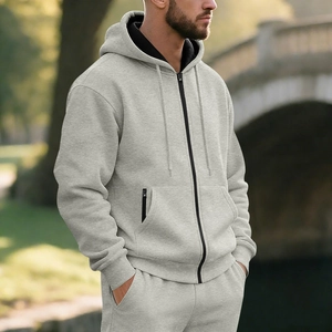 Close-up of light grey hooded sweatshirt with black contrast zipper and soft knit fabric