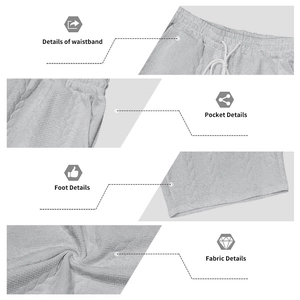 Detail view of men's knit shorts featuring elastic waistband with drawstring and textured fabric