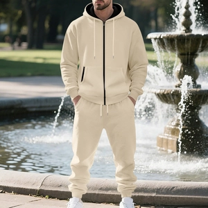 Detail view of beige zip-up hoodie set with black trim accents in outdoor setting