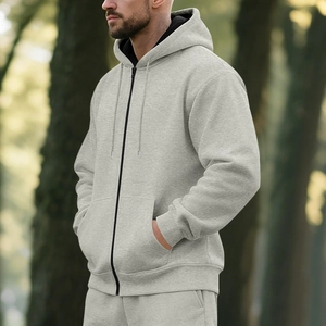Outdoor view of light grey fleece-lined zip-up hoodie and matching joggers set