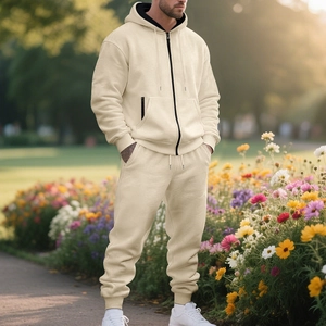 Close-up of beige heavy-fleece hoodie tracksuit with black zipper and drawstring detail