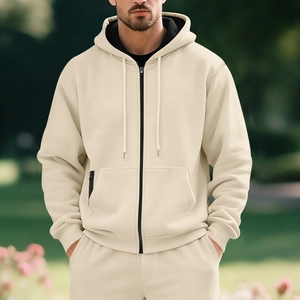 Detail of beige men's fleece hoodie with drawstring hood and decorative zipper pocket