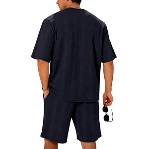Rear view of men's navy knit suit set showing detailed jacquard texture and premium fit
