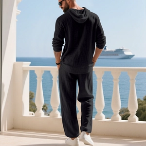 Men's casual black linen set with hooded shirt and pants for vacation on a balcony