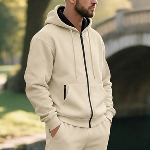 Detail of men's beige fleece hooded tracksuit with black metal zipper and ribbed cuffs